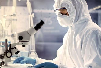 Scientist surveying genomic samples under microscope